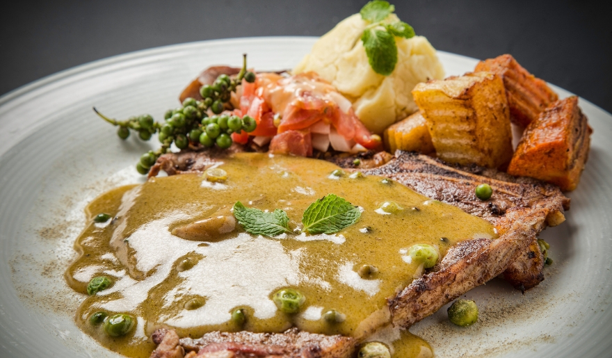 A delicious meal of steak, potatoes, and gravy served on a plate at Café Old Vienna, a dining spot in Myrtle Beach.